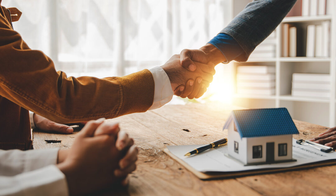 A handshake, a home, and documents being signed to finance a roof