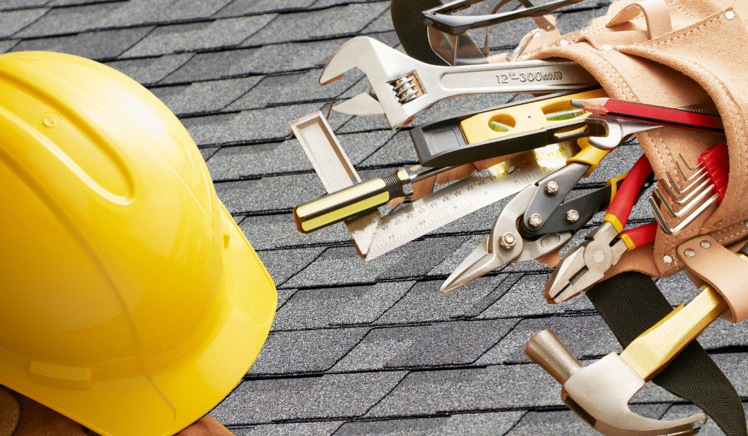 Home maintenance tools on top of a shingle roof